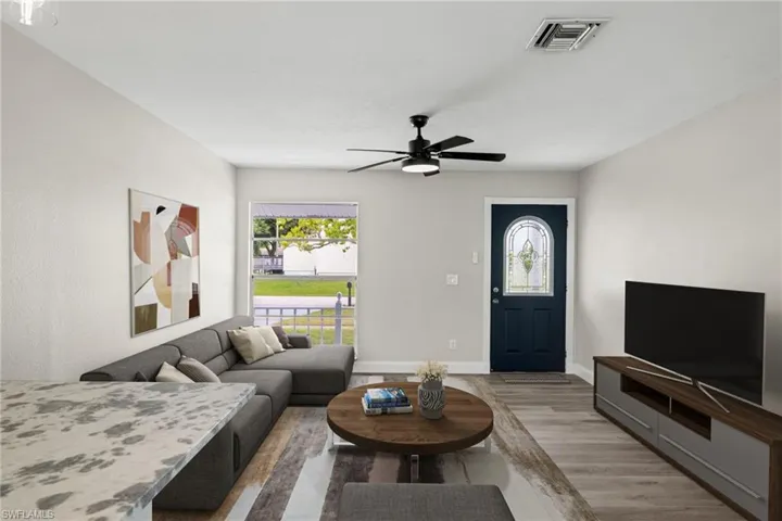 Living room featuring ceiling fan and light wood-type flooring