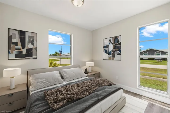 Bedroom featuring multiple windows and light wood-type flooring