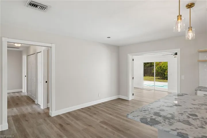 Empty room featuring hardwood / wood-style flooring and ceiling fan