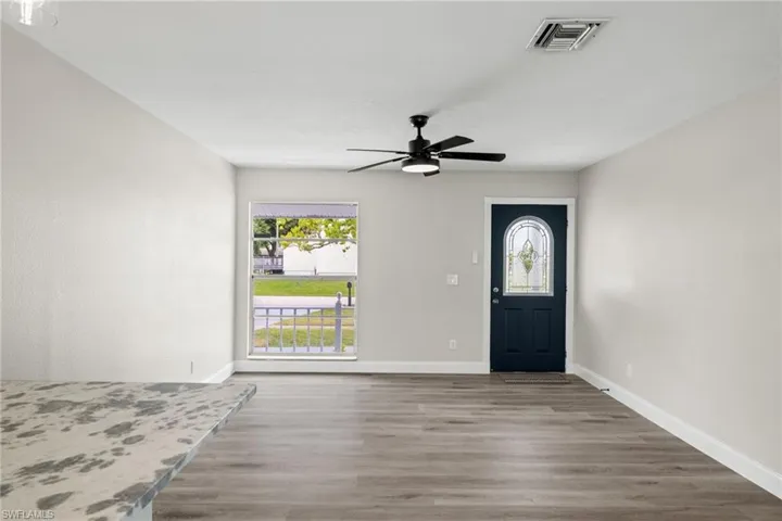 Entryway featuring ceiling fan and hardwood / wood-style flooring