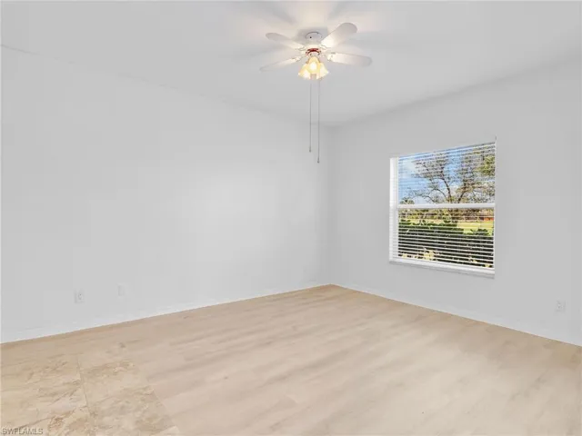 Empty room with light wood finished floors and ceiling fan