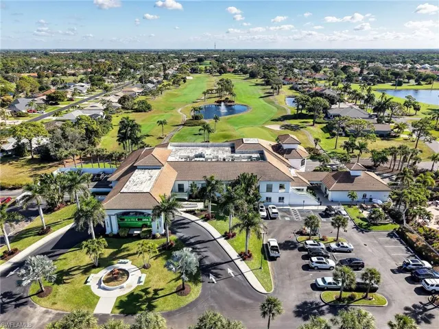 Aerial perspective of suburban area with a large body of water and a golf course