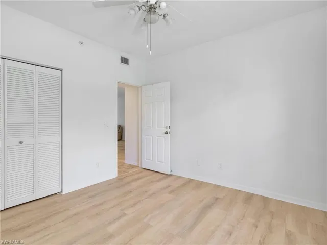 Unfurnished bedroom with a closet, light wood-type flooring, and ceiling fan
