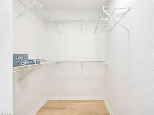 Spacious closet with light wood-style flooring