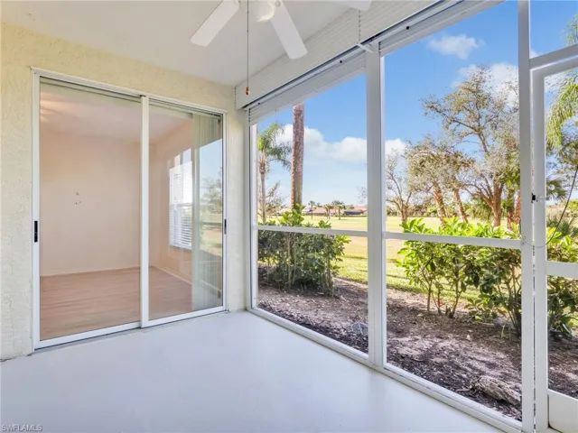 Unfurnished sunroom with finished concrete flooring and golf course view