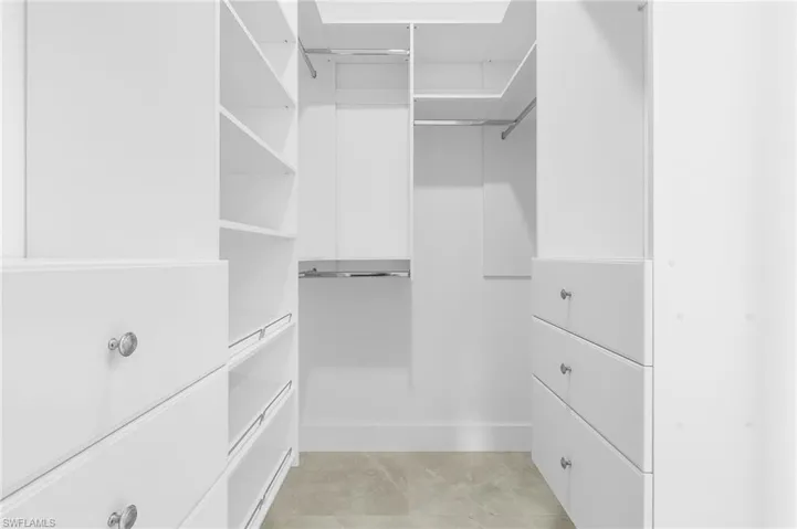 Spacious closet featuring light tile patterned floors
