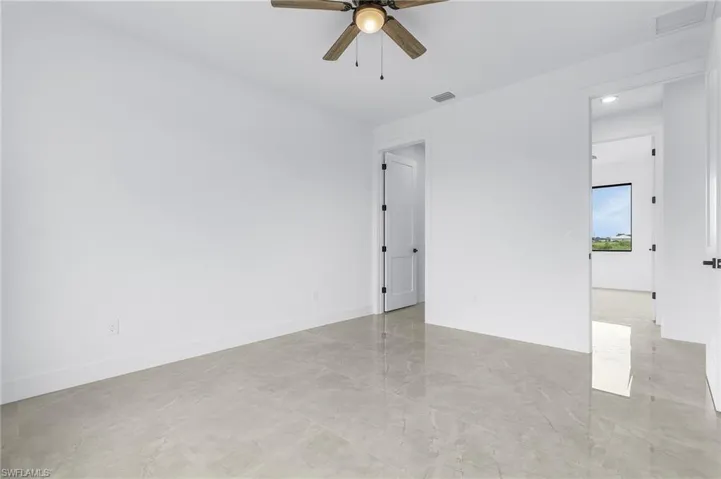 Spare room with light tile patterned floors and ceiling fan