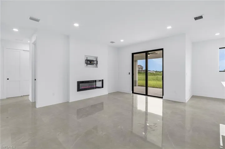 Unfurnished living room featuring light tile patterned floors