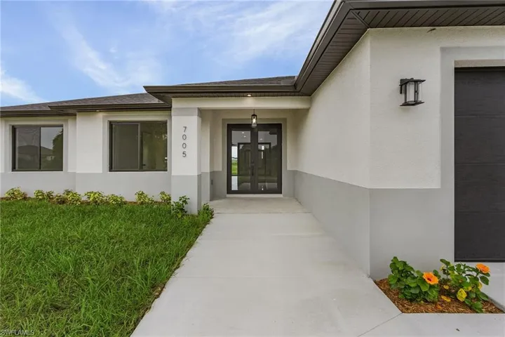 Property entrance featuring a garage and french doors