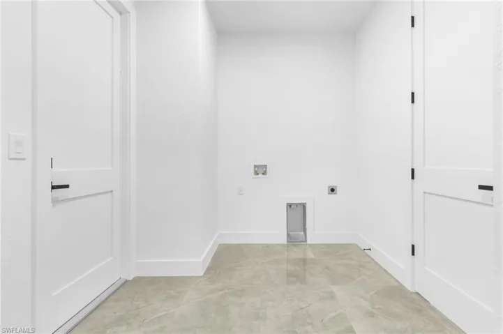 Laundry area featuring hookup for a washing machine, light tile patterned floors, and electric dryer hookup
