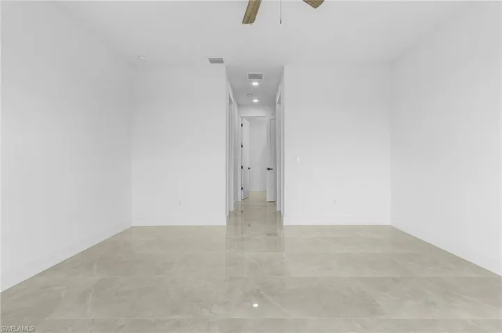Tiled empty room with ceiling fan