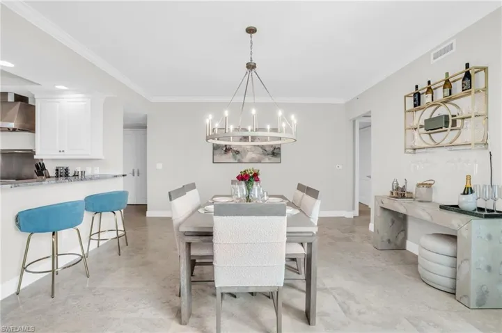Dining area with a chandelier and ornamental molding