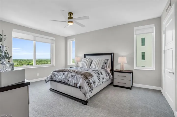 Bedroom with light colored carpet and ceiling fan
