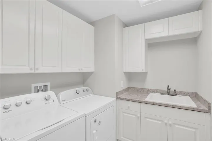 Laundry area featuring washing machine and clothes dryer and sink