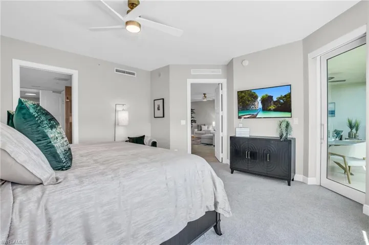 Bedroom with access to exterior, light carpet, and ceiling fan