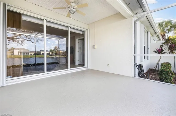 View of patio with a water view and ceiling fan