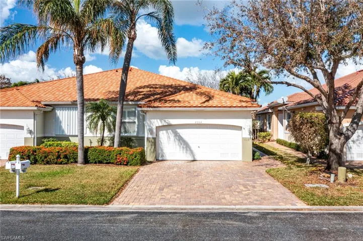 View of front of house featuring a front yard and a garage