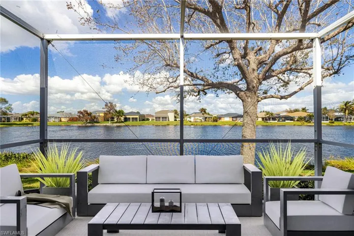 Virtual enhanced furniture on sunroom with a water view