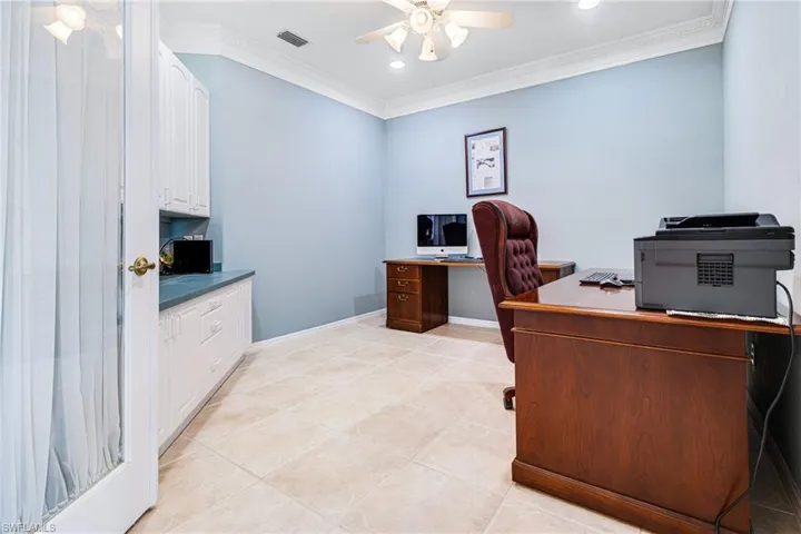 Tiled office featuring crown molding and ceiling fan