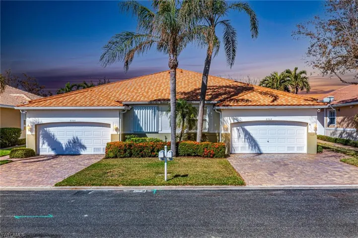 View of front facade featuring a yard and a garage