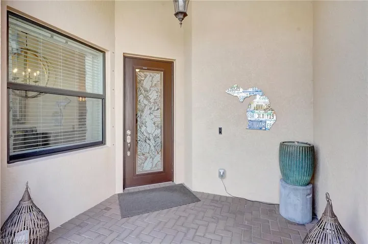 Doorway to property featuring stucco siding