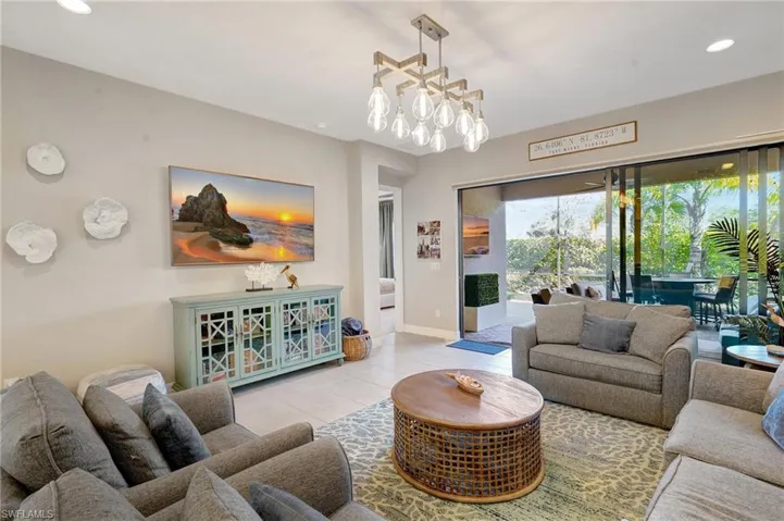Living area with an inviting chandelier, tile patterned flooring, baseboards, and recessed lighting