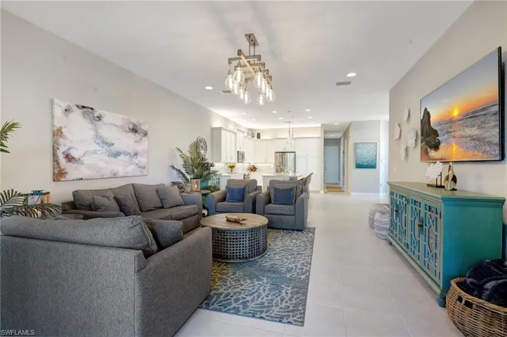 Living room featuring light tile patterned floors, visible vents, and recessed lighting