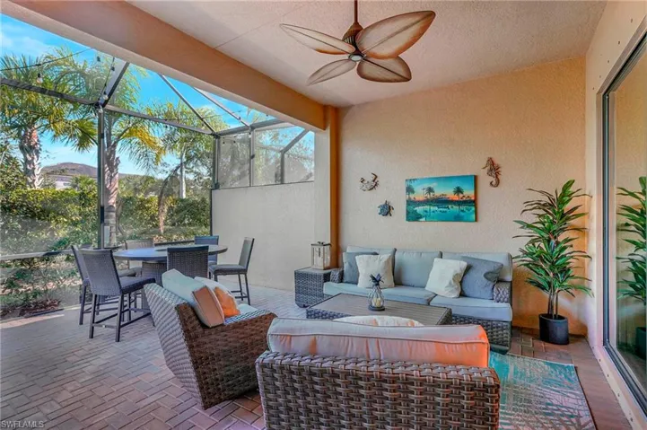 View of patio / terrace featuring a ceiling fan, glass enclosure, outdoor dining area, and outdoor lounge area