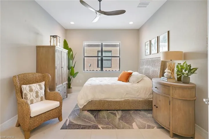 Bedroom featuring baseboards, visible vents, ceiling fan, light tile patterned flooring, and recessed lighting