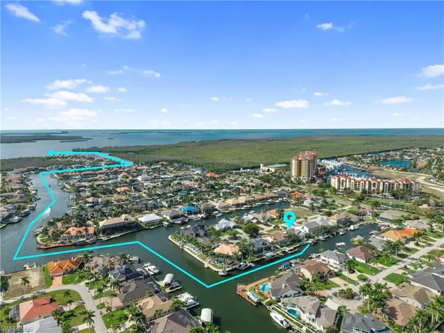 Aerial perspective of suburban area featuring a nearby body of water