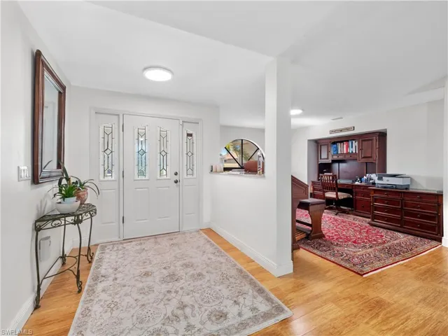 Foyer featuring light wood finished floors and baseboards