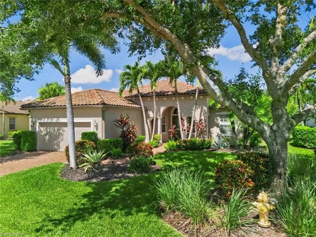 Mediterranean-style residence featuring a tile roof and stucco exterior