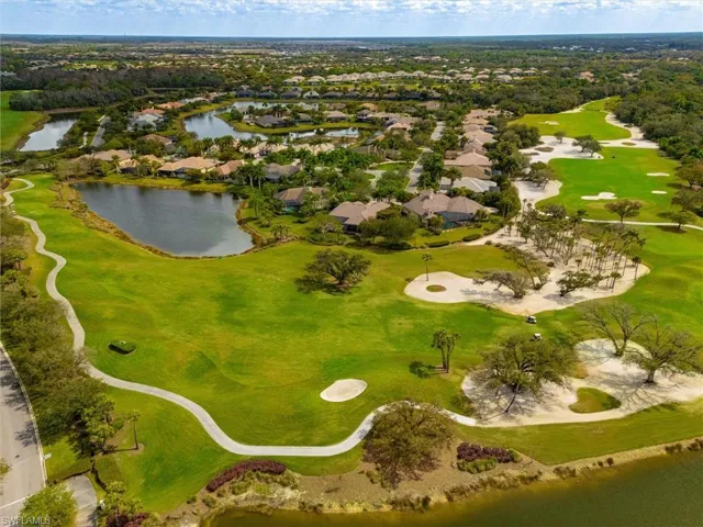 Expansive golf course setting featuring manicured greens and multiple sand traps