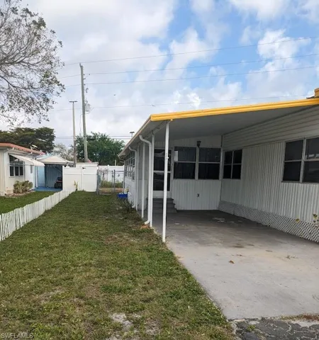 View of home's exterior with an attached carport and concrete driveway