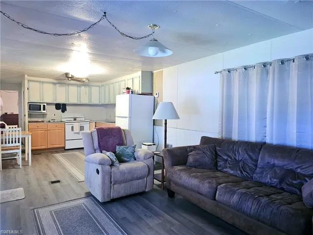 Living area featuring wood finished floors and a textured ceiling