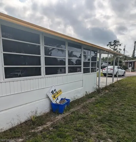 View of property exterior with a yard