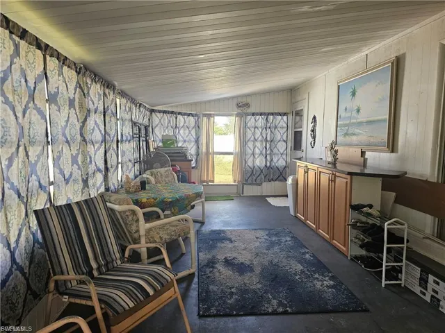 Sunroom / solarium featuring lofted ceiling