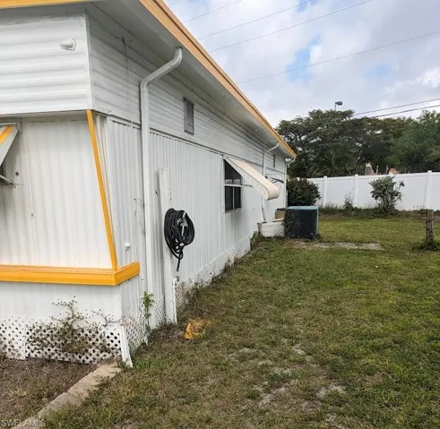 View of side of property with a central AC unit