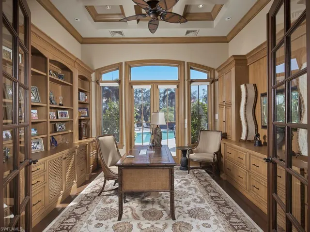 Office with french doors, ceiling fan, crown molding, high coffered ceiling, and dark wood-style floors