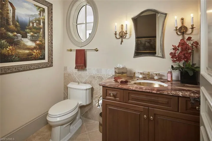Bathroom featuring vanity, tile walls, and light tile patterned floors