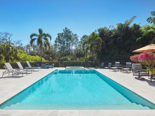 Relaxing pool / spa featuring a patio area