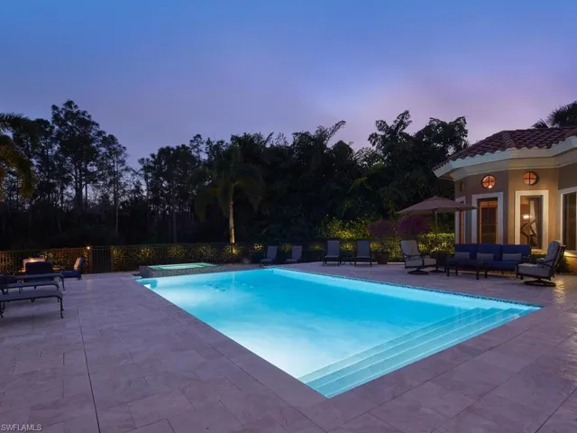 Integrated pool / hot tub with a patio and an outdoor living space
