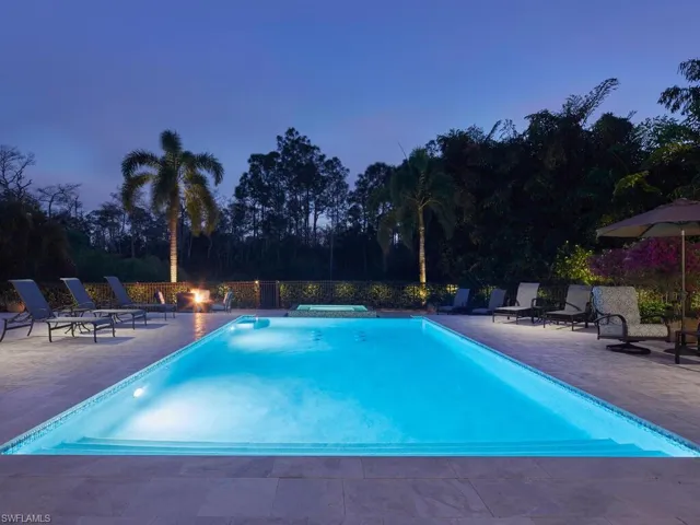 Pool at dusk featuring a patio