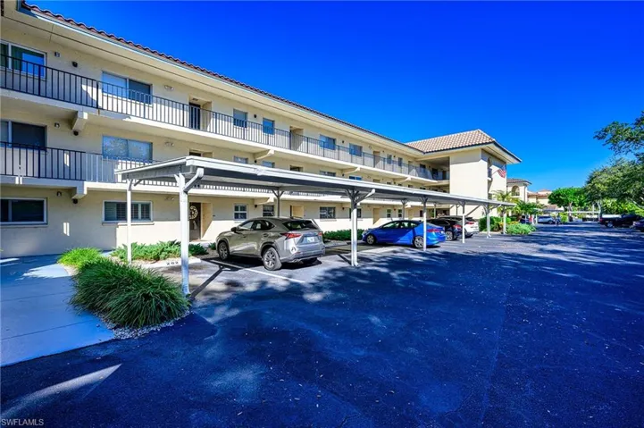 View of covered carport and common elevator.