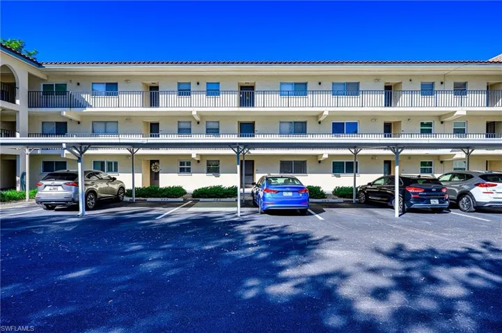 View of condo and parking right outside of door. (blue car spot)