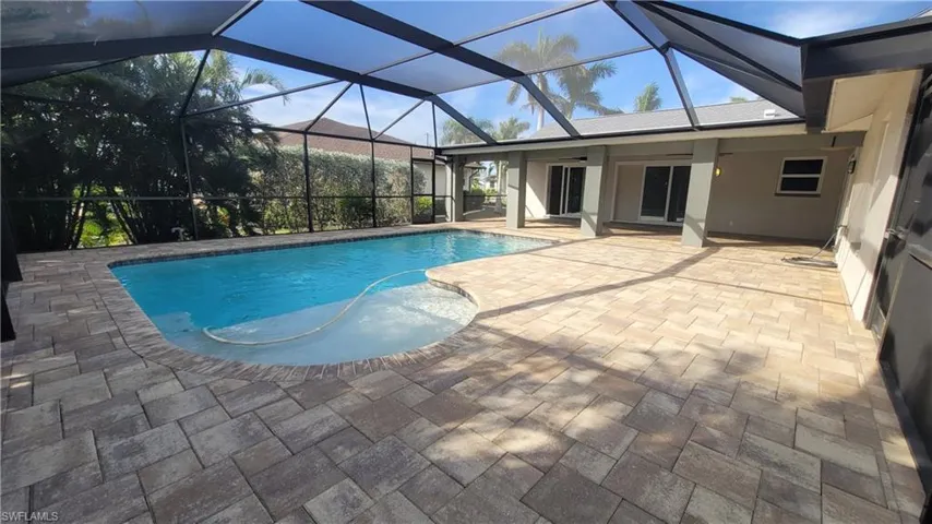 View of pool with ceiling fan, a lanai, and a patio