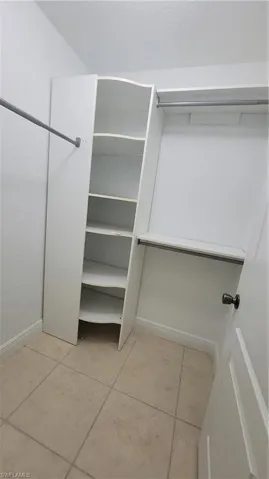 Spacious closet with light tile patterned floors
