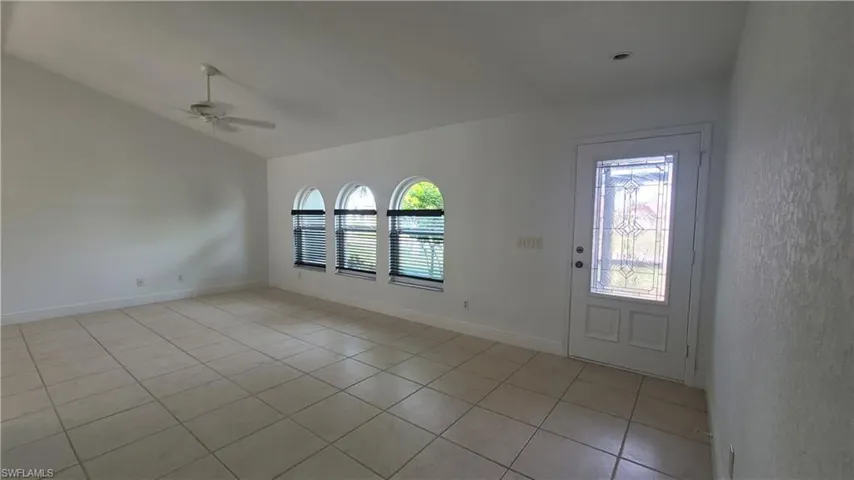 Entrance foyer with ceiling fan and light tile patterned floors