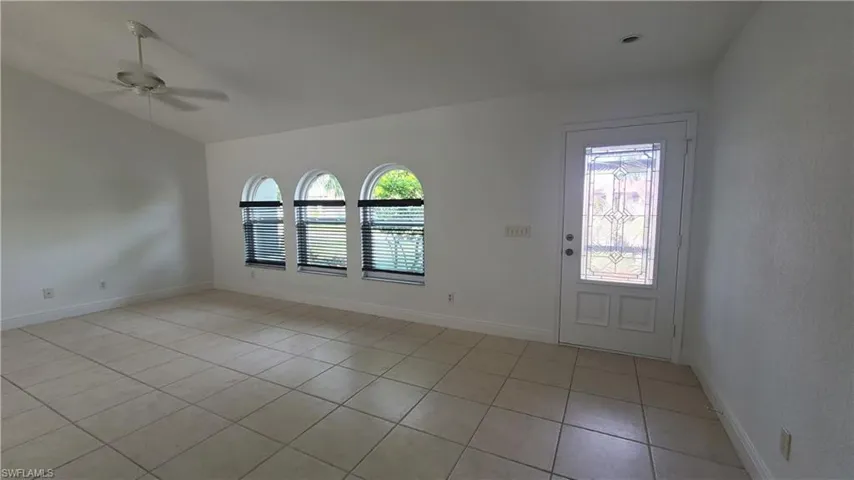 Tiled foyer entrance featuring ceiling fan