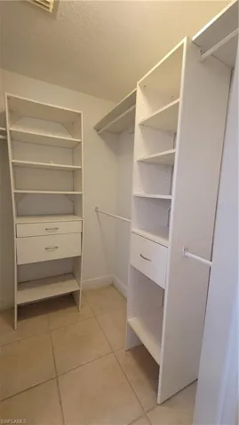 Spacious closet featuring light tile patterned flooring